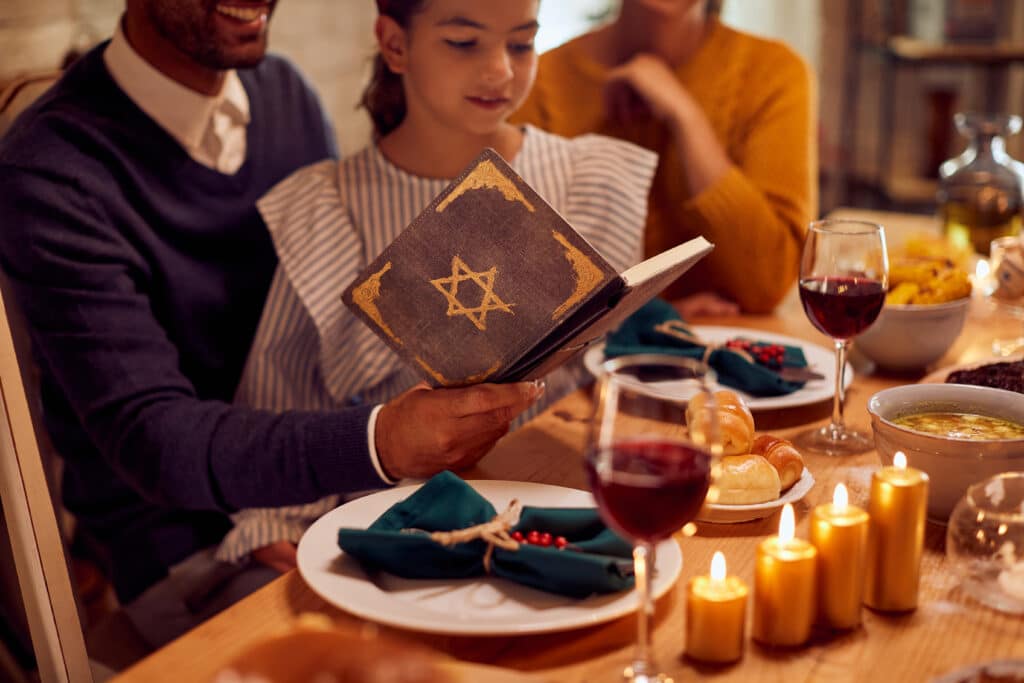 Close-up of Jewish family reading Tanakh before a meal