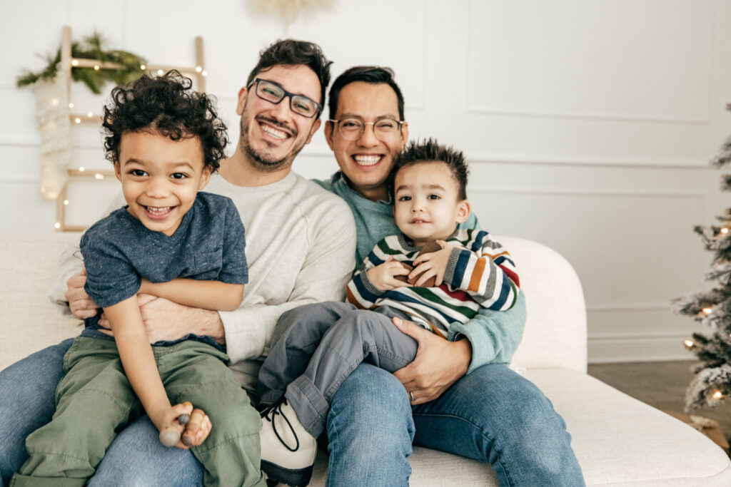 Male parents with two happy children
