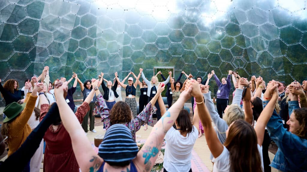 women raising their hands in a circle